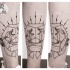 Strange looking black ink leg tattoo of foxes with various ornaments