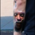 Strange looking colored arm tattoo of ripped skin with woman face