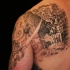 Stunning black and white back and shoulder tattoo of corrupted city