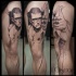 Stunning black and white thigh tattoo of thug like man
