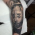 Stunning black ink sleeve tattoo of demonic man face
