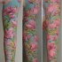 Stunning natural colored sleeve tattoo of pink flowers with leaves