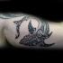Superior black ink biceps tattoo of Polynesian style shark