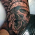 Superior black ink elbow tattoo of Indian skull