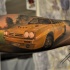 Superior designed and colored forearm tattoo of yellow race car
