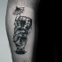 Surrealism style black ink arm tattoo of monster hand holding glass