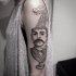 Surrealism style black ink shoulder tattoo of man statue with lettering and clouds