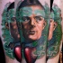 Surrealism style colored arm tattoo of man with electronics and apple