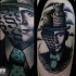 Surrealism style colored shoulder tattoo of man face with castle like hat