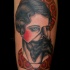 Surrealism style colored shoulder tattoo of half man half woman portrait