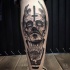 Surrealism style creepy looking black ink demonic man head tattoo on leg
