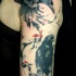 Sweet looking colored shoulder tattoo of flying crows and blooming tree