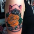 Sweet looking colored shoulder tattoo of beautiful cat with cup and rose