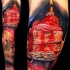 Tasty looking colored cake slice with strawberry and candle tattoo on biceps