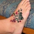 Buisson avec le tatouage de fleurs sur la cheville