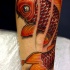 Tatouage sur le bras de poisson rouge