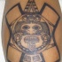Tatuaje de una piedra de sol primitiva azteca.