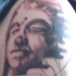budda pietra viso tatuaggio