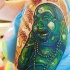 budda pietra verde sorridente tatuaggio