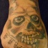 Skull with golden tooth tattoo