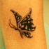 tribale trafori farfalla ali tatuaggio