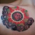 Red all-seeing eye  chest tattoo