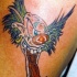 pazzo pagliaccio con percing colorato tatuaggio