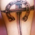 Tatuaje de una herradura y un cruz de hierro