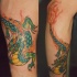 irato verde drago fuoco tatuaggio