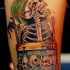 scheletro sorridente con tamburro tatuaggio