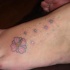 Le tatouage d'hibiscus avec les étoiles brillantes sur la pied