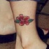 tatuaje en la pierna de flor roja de hibisco