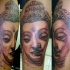 tatuaje de la cara del buda de piedra
