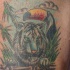 Tatuaje asiático tigre con cacatúa en el bosque