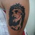 Tatuaje negro retrato de Jesús con gotas de sangre