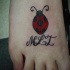 Le tatouage de coccinelle minimaliste avec des initiales