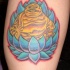 el tatuaje de una flor de loto azul con un buddha de oro adentro