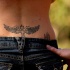 Tatuaje en bajo de la espalda, cruz con alas en tinta negra