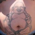 Bouddha joyeux tatouage nombril