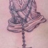 Rosary and old praying hands tattoo