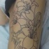Tatuaje en el costado, tres flores preciosas en tinta negra