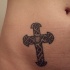 Tatuaggio sulla pancia la croce rabescato