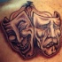 Tatuaje con antifaces teatrales en tinta negra