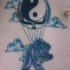 Precioso tatuaje del oso en el globo yin yang