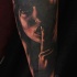 Terrifying black ink forearm tattoo of dark woman face