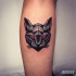 Tiny colored leg tattoo of geometrical demonic cat