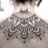 Traditional black ink back tattoo of impressive ornaments