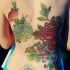 Traditional painted colored chrysanthemum flowers tattoo on back with insects