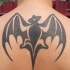 Tatuaje en la espalda, silueta de  murciélago, estilo tribal