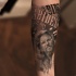 Typical black ink famous actor portrait tattoo stylized with lettering